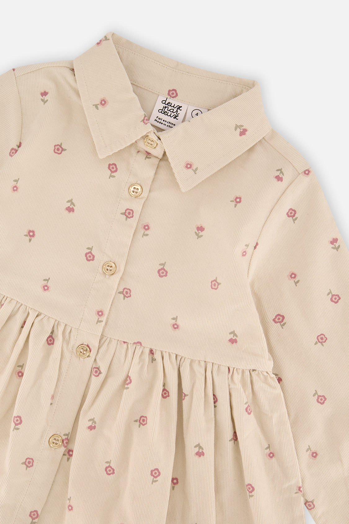 Close-up of the collar and buttons and flower print on the Deux par Deux corduroy dress