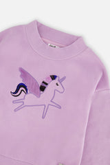 Close-up of the winged unicorn embroidery and crew neckline on the Deux par Deux violet dress