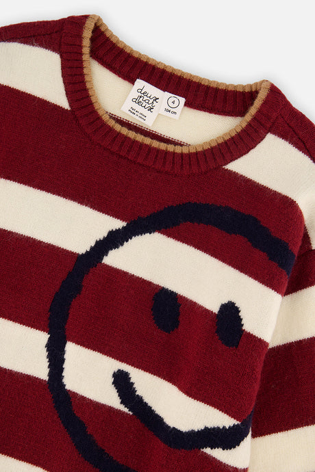 Close-up of the textured navy smiley face and tan-trimmed ribbed neckline on the burgundy and cream striped Deux par Deux sweater