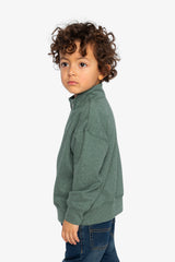Child wearing the dark green half-zip sweater, side view