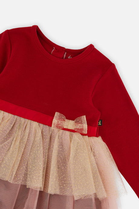 Close-up of the bow belt and glittering mesh tiers on the Deux par Deux red dress
