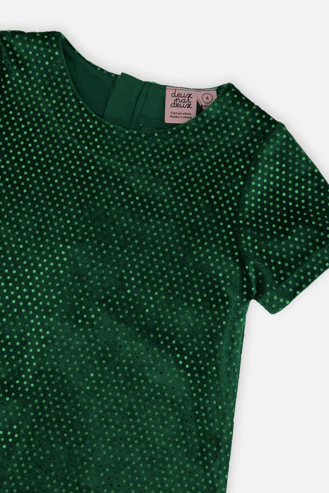Close-up of the sparkle dots and neckline on the Deux par Deux forest green dress