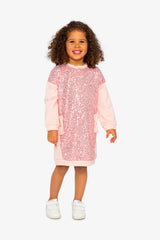 Child wearing the dusty pink sequin sweatshirt dress, front view