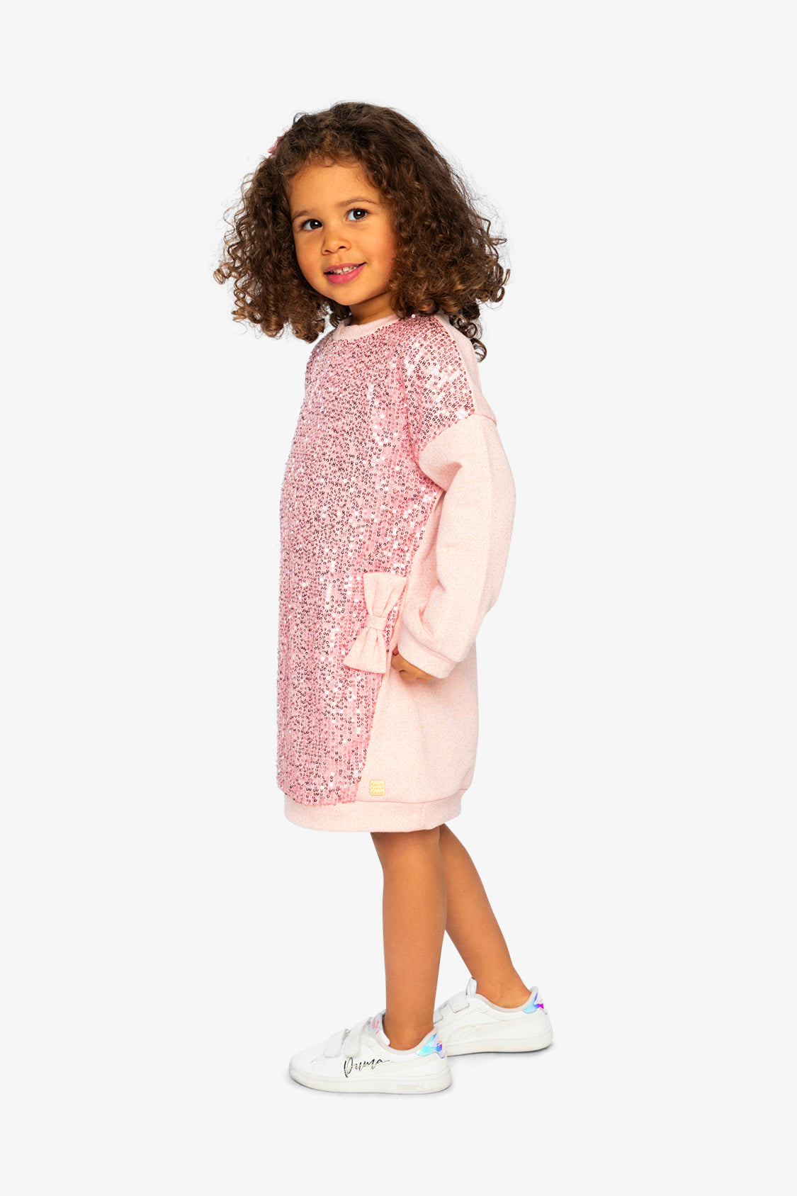 Child wearing the dusty pink sequin sweatshirt dress, side view