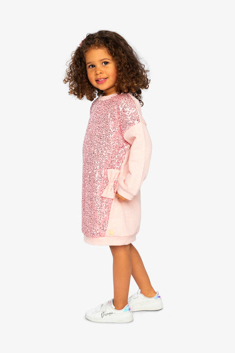 Child wearing the dusty pink sequin sweatshirt dress, side view