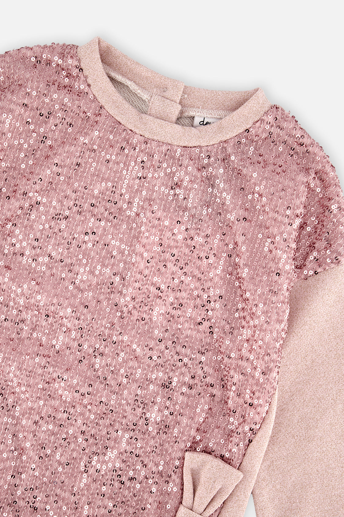 Close-up of the pink sequins and bow on the dusty pink sweatshirt dress