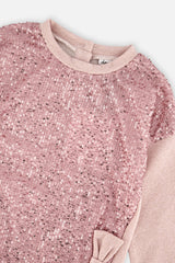 Close-up of the pink sequins and bow on the dusty pink sweatshirt dress