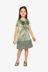Child wearing the Deux par Deux greyish green velour dress with a bow and gold shoes