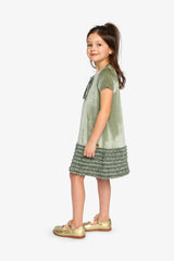 Child wearing the Deux par Deux greyish green velour dress, side view