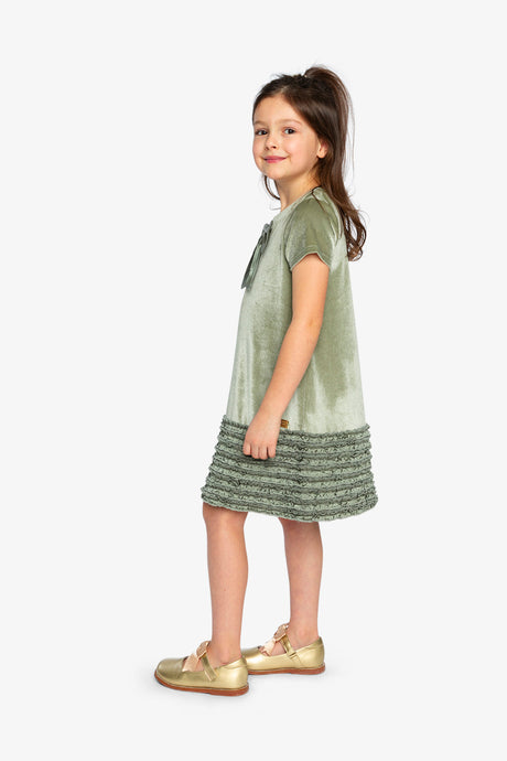 Child wearing the Deux par Deux greyish green velour dress, side view