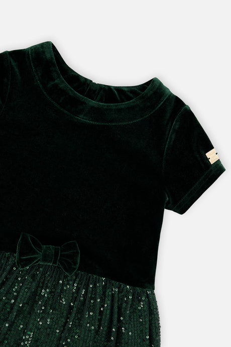 Close-up of the velvet neckline and bow on the Deux par Deux green party dress