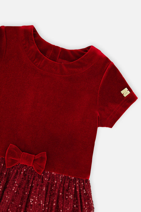Close-up of the velvet neckline and bow on the Deux par Deux red party dress