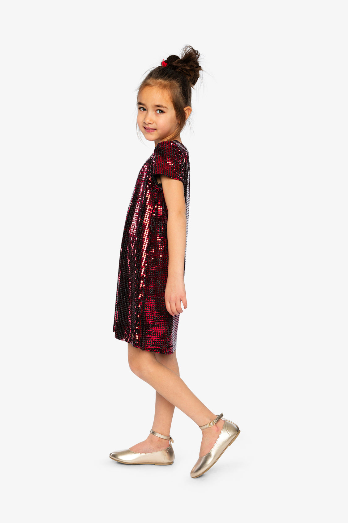 Child wearing the Deux par Deux red metallic A-line dress, side view