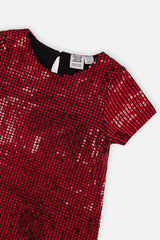 Close-up of the red metallic shimmer and neckline on the Deux par Deux party dress