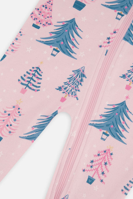 Close-up of the decorated teal and pink trees and white stars on the pink pajama beside the zipper