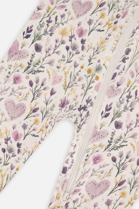 Close-up of the lilac hearts and purple, yellow and green wildflowers beside the zipper on the beige pajama