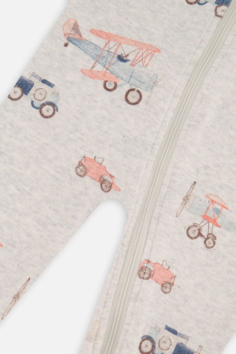 Close-up of the front zipper and biplane and car print on the beige baby footed pajama