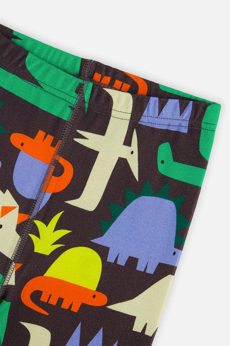 Close-up of the pants waist and leg seam covered in green and blue and orange dinosaurs