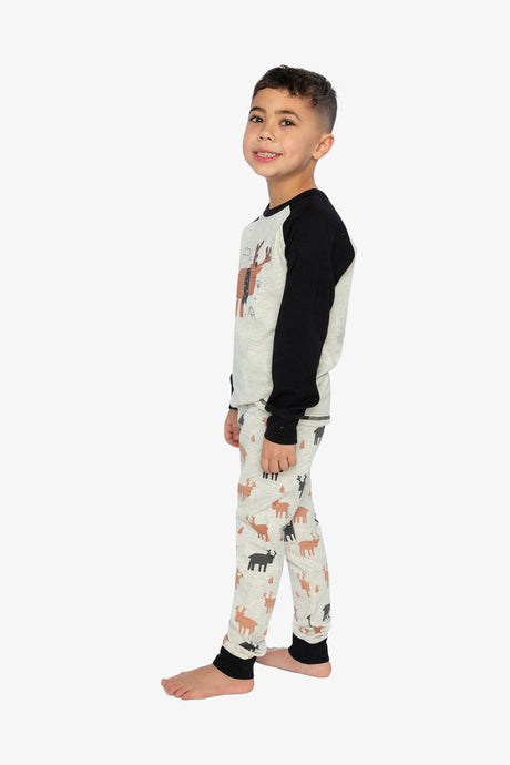 Child wearing the elk print pajama set in a side view showing the black sleeve and the elk pants