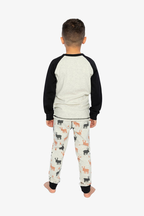 Back view of a child in the plain oatmeal pajama top with black sleeves and elk print pants