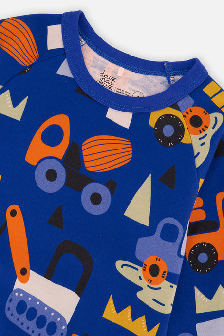 Close-up of the royal blue ribbed neckband and raglan seam with orange trucks and diggers on the top