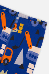 Close-up of the blue pants leg with orange digger and truck shapes and a stitched leg seam