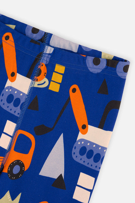 Close-up of the blue pants leg with orange digger and truck shapes and a stitched leg seam