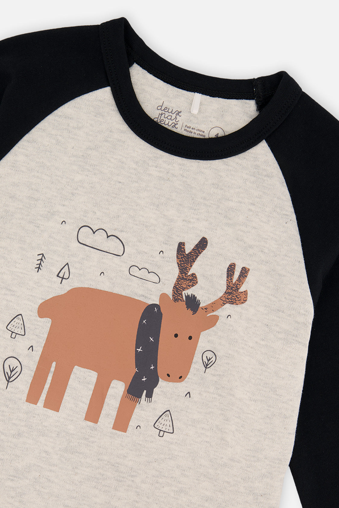 Close-up of the orange elk in a charcoal scarf and the black neckband on the oatmeal pajama top