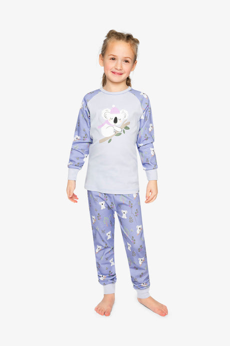Child wearing the purple koala pajama set standing and smiling