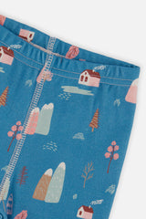 Close-up of the elastic waistband and house and mountain print on the blue pants
