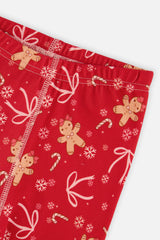 Close-up of the elastic waistband and gingerbread and bow print on the red pants