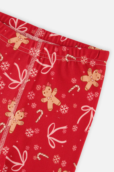 Close-up of the elastic waistband and gingerbread and bow print on the red pants