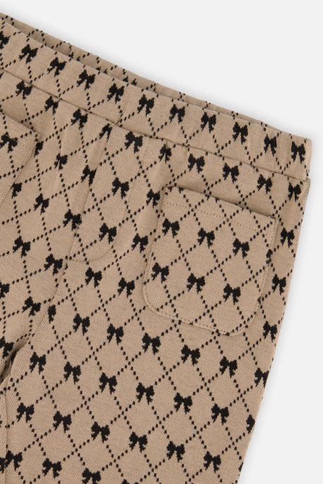 Close-up of the bow print and back pocket on the Deux par Deux beige treggings