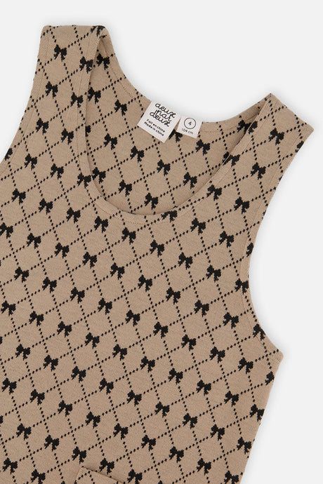 Close-up of the neckline and black bow and diamond print on the Deux par Deux jumper dress
