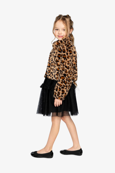 Child in the brown leopard faux fur jacket with a black tulle skirt, full-body side view