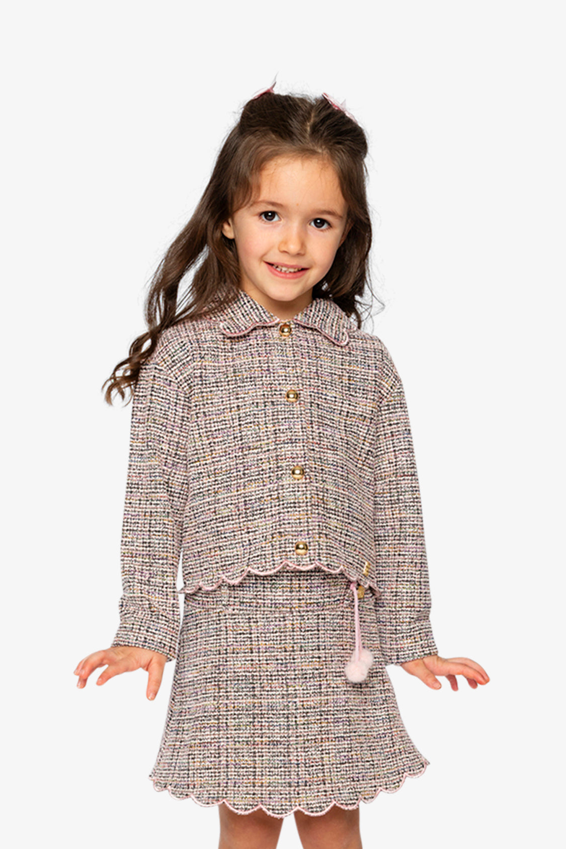 Child wearing the pink and black Deux par Deux cropped jacket with a skirt, front view