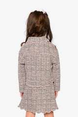 Child wearing the pink and black Deux par Deux cropped jacket with a skirt, back view