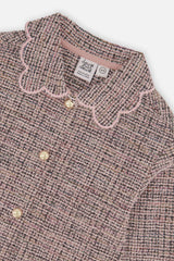 Close-up of the pink scalloped collar and round buttons on the pink and black Deux par Deux jacket