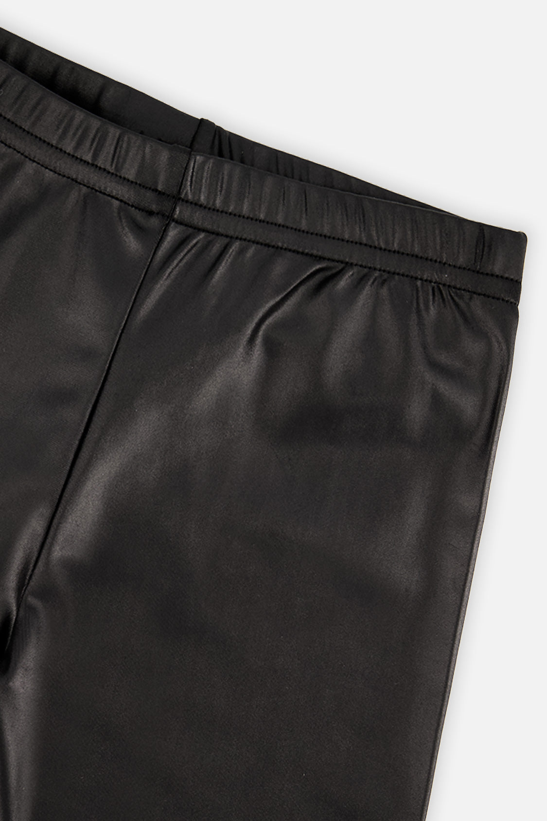 Close-up of the glossy faux leather and elastic waistband on black leggings