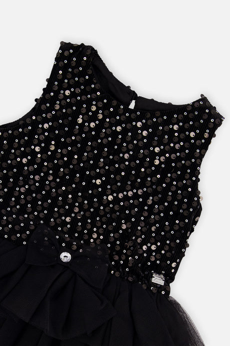 Close-up of the sparkling bodice and bow at the waist of the Deux par Deux black dress