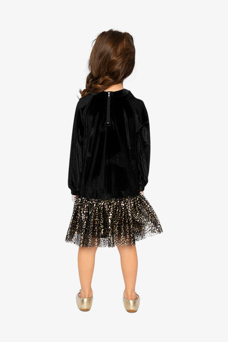 Child wearing the Deux par Deux black velour dress with a gold leopard skirt, back view