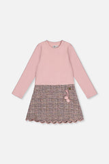Front view of the pink and black knit dress with a pink rib bodice and patterned skirt