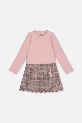Front view of the pink and black knit dress with a pink rib bodice and patterned skirt