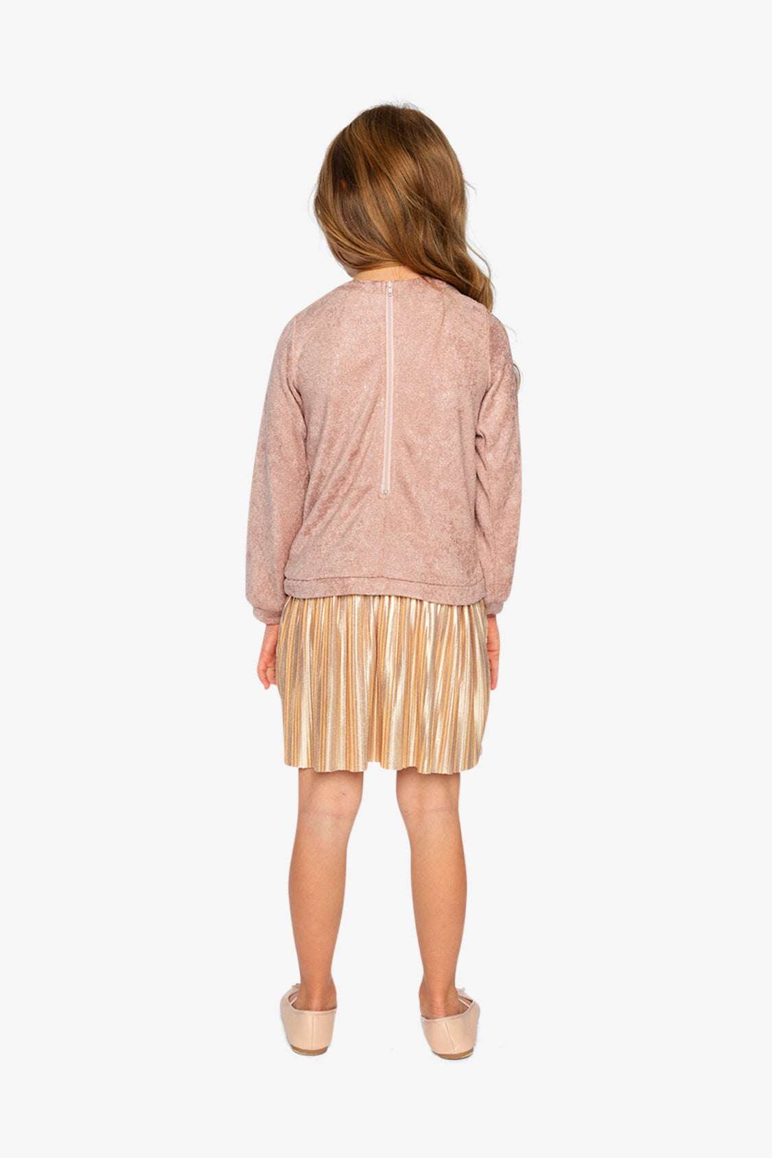 Child wearing the Deux par Deux dusty pink dress with a pleated skirt, back view