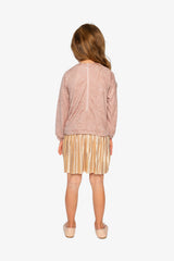 Child wearing the Deux par Deux dusty pink dress with a pleated skirt, back view