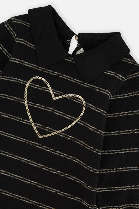Close-up of the gold sequin heart, collar and gold stripes on the black knit