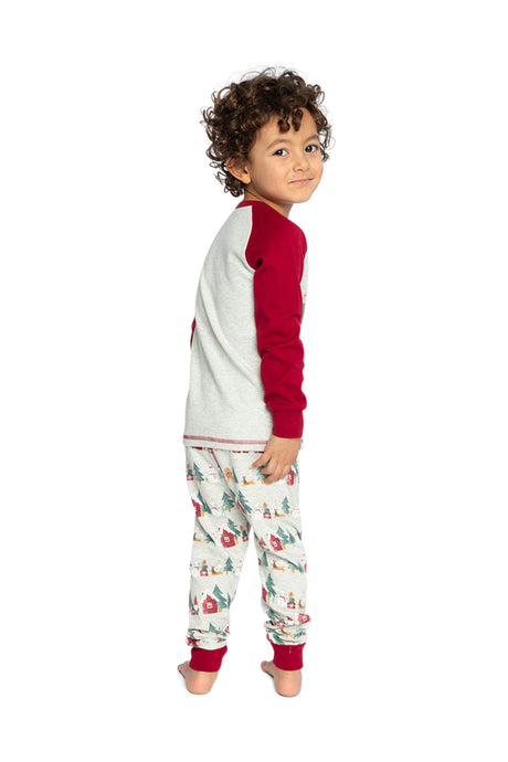 Child wearing the beige Christmas pajama set looking back over the shoulder
