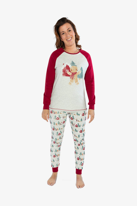 Woman wearing the Christmas PJs facing the camera with red cuffs at the ankles