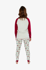 Woman wearing the Christmas pajama set from behind with red sleeves and printed pants