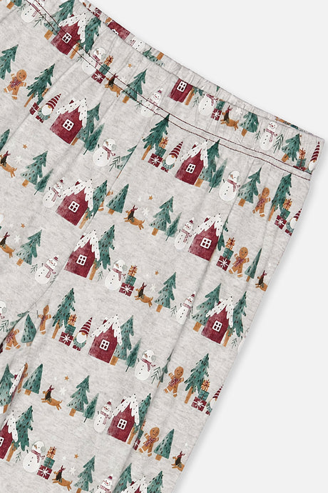 Close-up of the pants waist covered in red houses and pine trees and snowmen and gingerbread figures